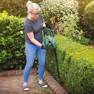 Bosch EasyHedgeCut 18-45 Cordless Hedge Cutter in use.