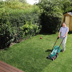 Bosch Rotak 34R Electric Rotary Lawnmower in use.