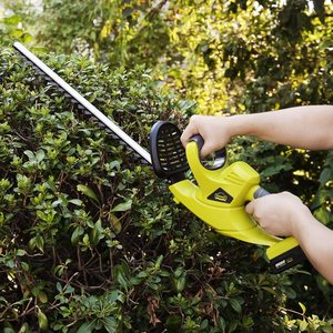 DEWINNER Cordless Hedge Trimmer in use.