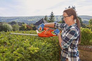 Flymo EasiCut 460 Hedge Trimmer in use.
