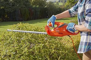 Flymo EasiCut 520 Electric Hedge Trimmer in use.