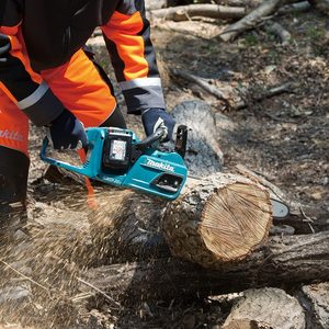 Makita DUC355Z Chainsaw in use.