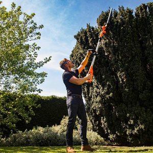 Yard Force 20V Cordless Pole Hedge Trimmer in use.