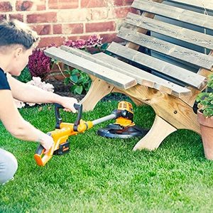 LawnMaster 24V 25cm Cordless Grass Trimmer cutting underneath a bench.