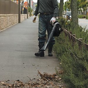 Makita BHX2501 Petrol Leaf Blower in use.