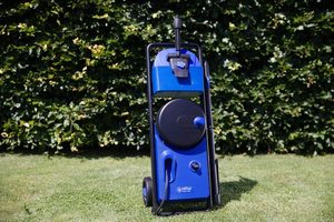 Nilfisk Core 140 In-Hand Power Control Pressure Washer in a garden.