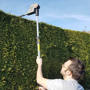 Terratek 20V Cordless Electric Hedge Trimmer in use.