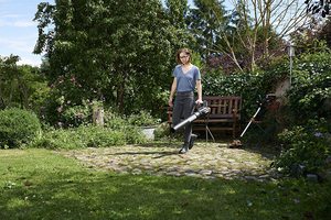 WORX WG547E Cordless Leaf Blower in use.